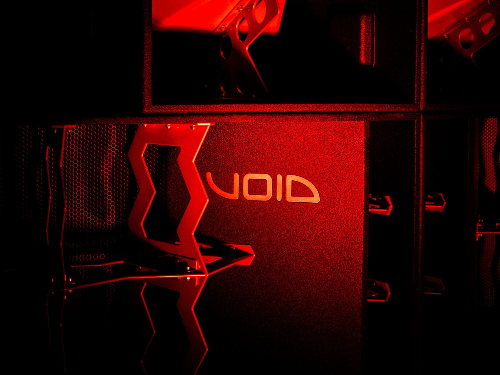 Void Acoustics speaker cabinet with logo, lit in red